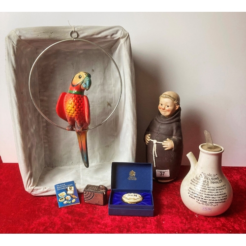 37 - A basket containing collectibles including a vintage ceramic inhaler, a wooden parrot and other extr... 