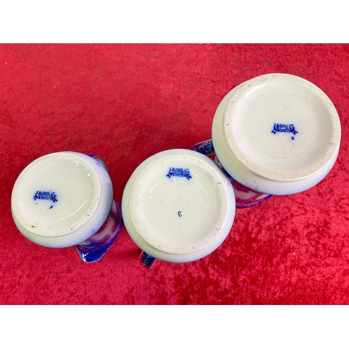 614 - Set of three Burslem blue and white graduated jugs