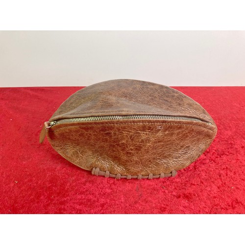 696 - An Osprey leather rugby ball shaped washbag