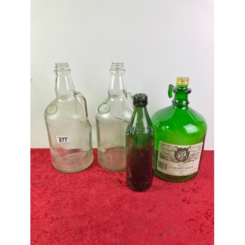 877 - 3 large glass bottles and a vintage white and green bottle