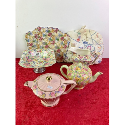 913 - Floral ceramic teapots, jugs, dishes, plates and a tea cosy