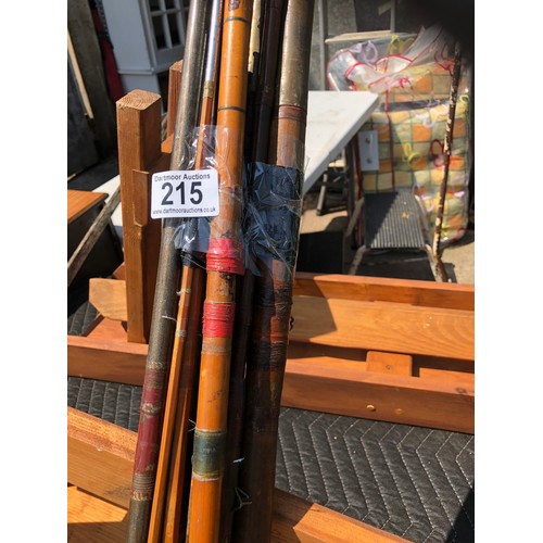 215 - A selection of cane fishing rods