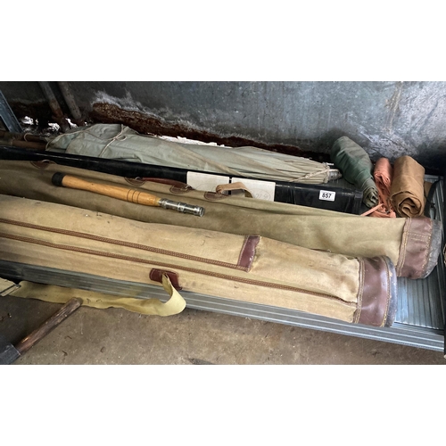 857 - Collection of vintage fishing rods in canvas carry bags, with brolly etc