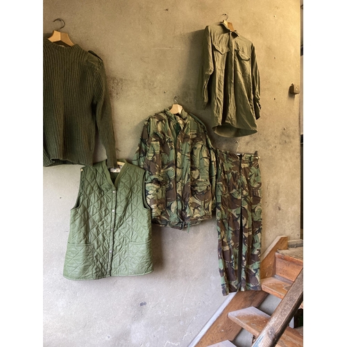 192 - Quantity of Army uniform, inc combat smock, trousers, shirt, jumper, boots, socks, & plimsolls