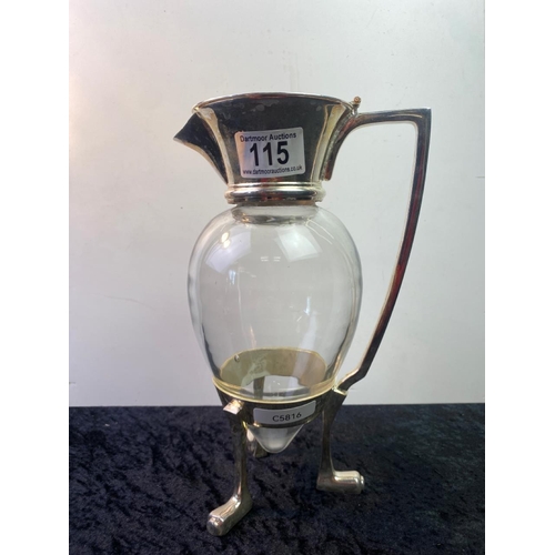 115 - Silver plate lidded carafe, tripod foot