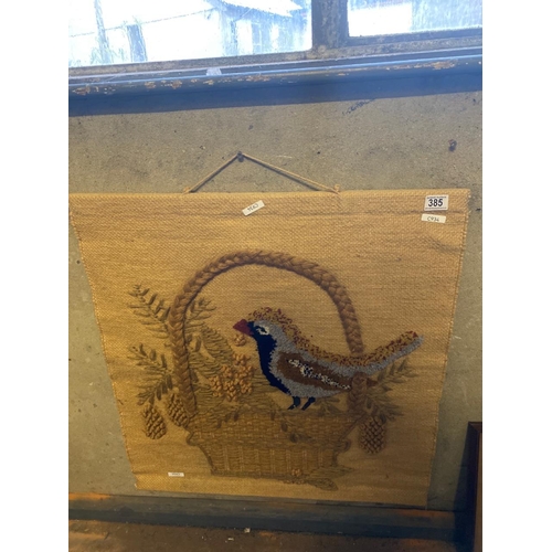 385 - Woolwork wall hanging depicting a bird in a wicker basket. Approx 73cm x 70cm