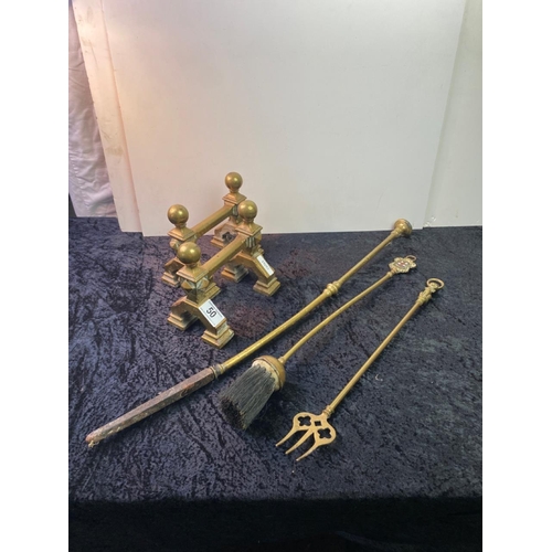 50 - Pair of brass fire dogs along with brass handled poker, toasting fork and brush