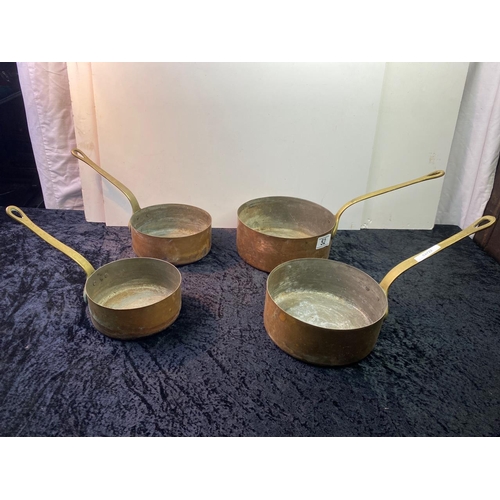 52 - Set of four graduated brass handled copper pans