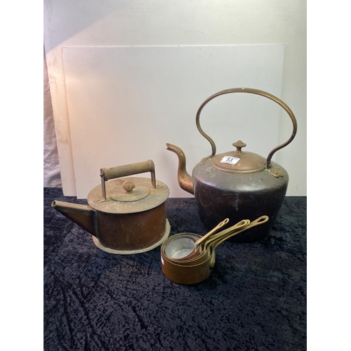 53 - Two copper kettles along with a small set of brass handled copper pans