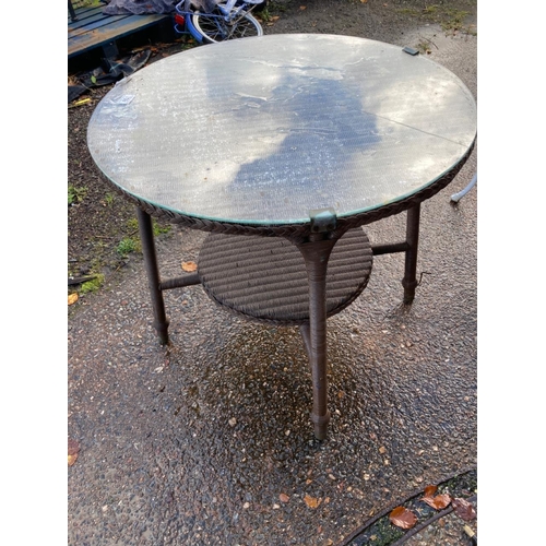 709 - Circular glass topped garden table, approx 76cm diameter, 70cm tall