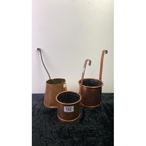 102 - Three copper measures, approx 10 and 12cm tall (excluding handles)