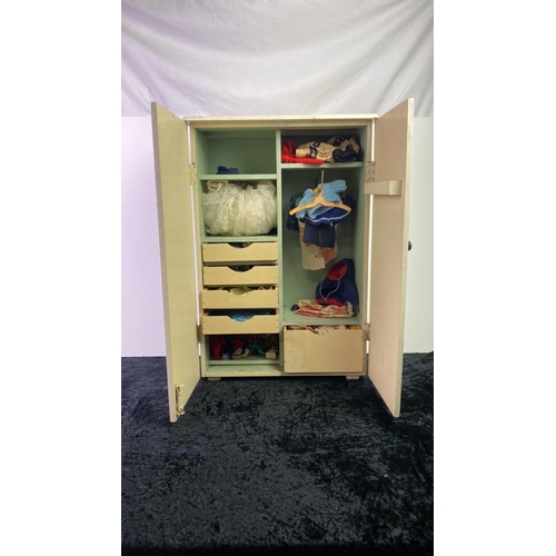 229 - A wooden doll’s wardrobe containing doll’s vintage doll’s clothes