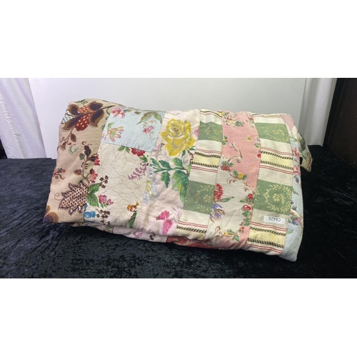 265 - A large vintage bedspread in a floral, patchwork style