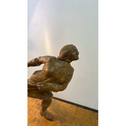 380 - Unusual carved wooden figurine of an ice skater on wooden plinth, approx 28cm tall (inc. plinth)