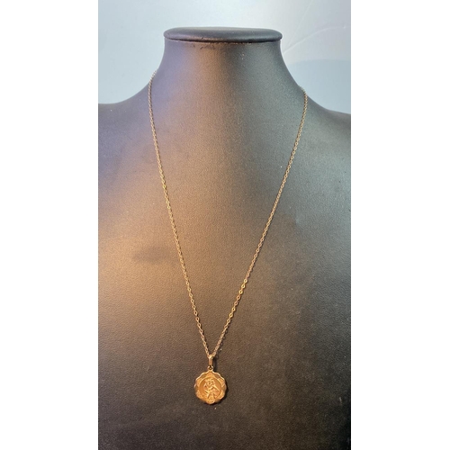 562 - A 9 carat gold St Christopher pendant on a 9 carat gold chain. Total weight 2.3g