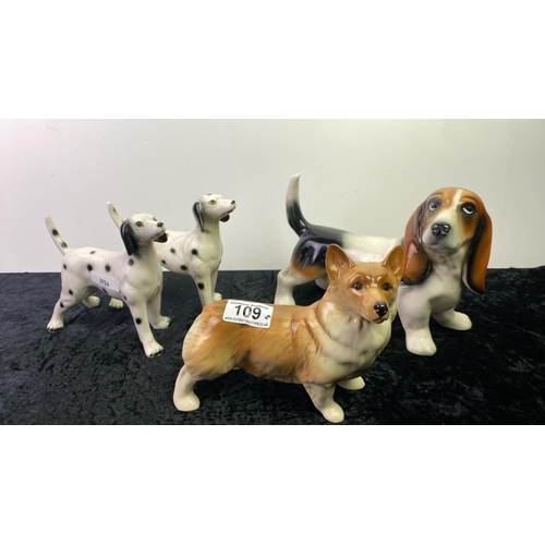 109 - Four Pottery dogs including a pair of dalmatians, a corgi and a basset hound - no  makers marks