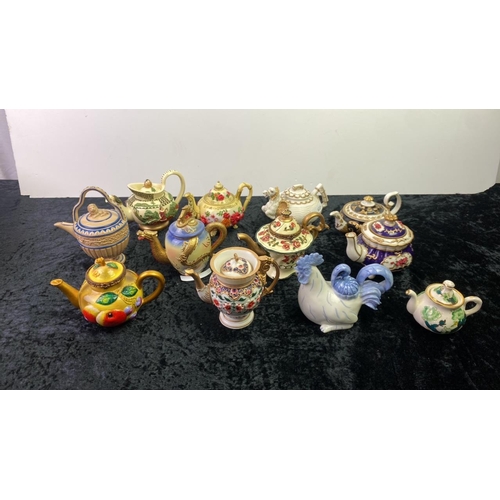 127 - A collection of miniature teapots