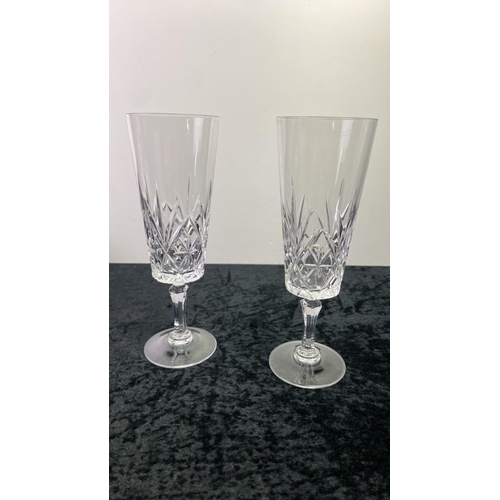 185 - A boxed set of tall crystal glasses