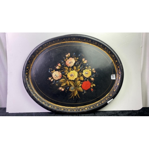 187 - A large oval metal tray with hand painted floral design and Abalone shell detail. Approx 60cm x 48cm