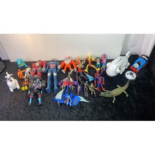 202 - A selection of toys including action figures, a remote control chameleon (what every house holder ne... 