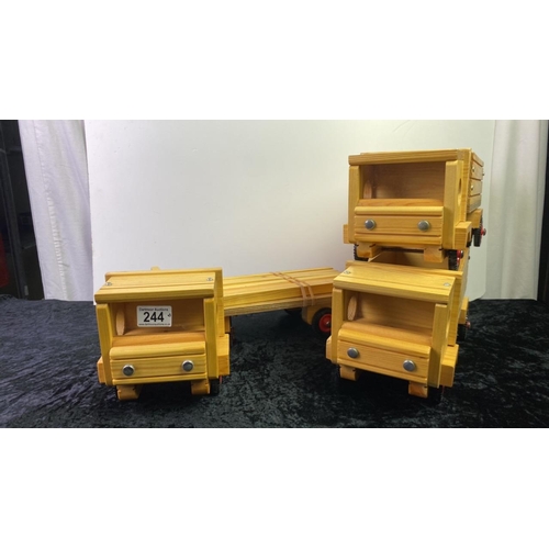 244 - Three wooden model toy trucks, inc one longer example with wooden ‘cargo’