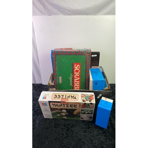 255 - Box of games inc Yahtzee, Scrabble, Backgammon, Trivial Pursuit cards, Beer Pong and more