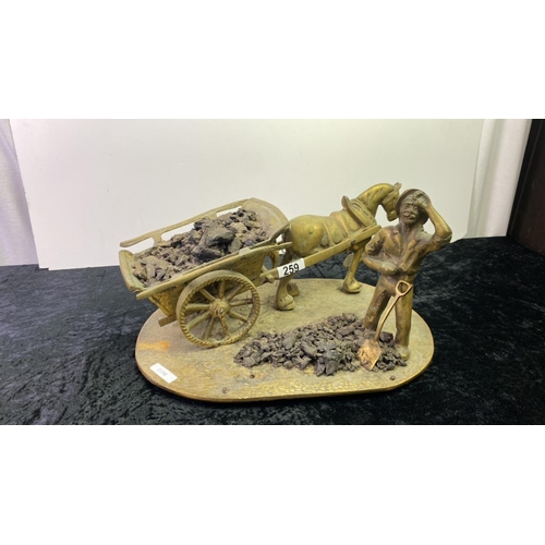 259 - A heavy, brass model of a coal miner with horse and cart. Approx width 34cm x 22cm