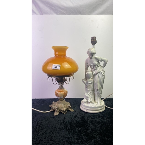 289 - Brass and marble electric lamp with amber colour glass shade along with a figurine lamp