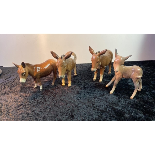 291e - Four Beswick donkey figurines, 11-14cm tall