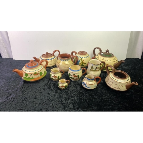 299 - Collection of Devon mottoware teapots and jugs