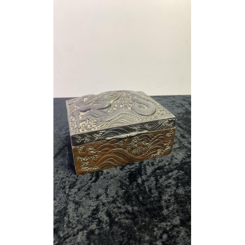 307 - Chinese wood lined metal trinket box with intricate dragon design. Maker’s marks to the base. Approx... 