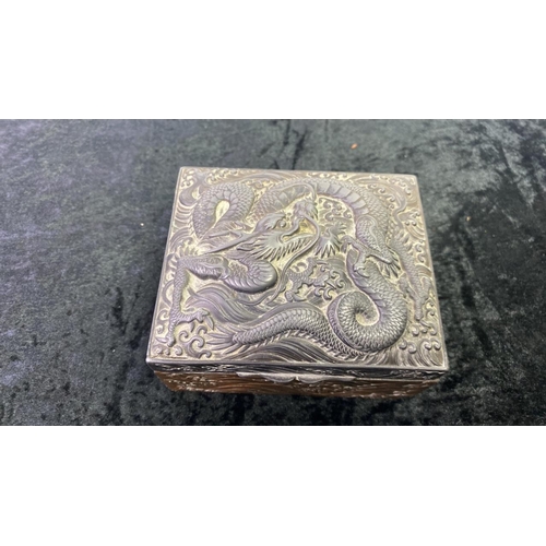 307 - Chinese wood lined metal trinket box with intricate dragon design. Maker’s marks to the base. Approx... 