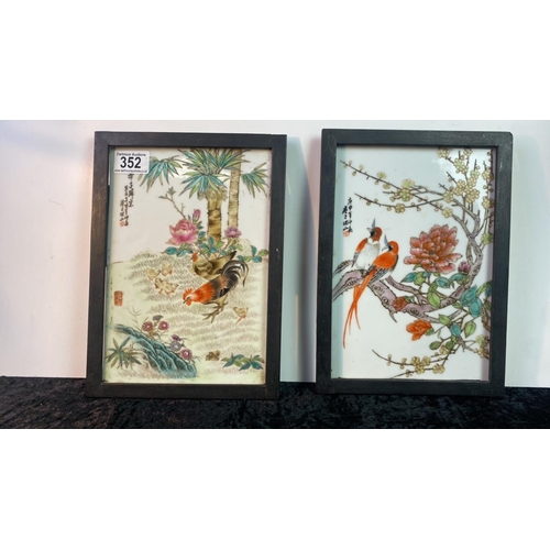 352 - Pair signed Chinese ceramic coloured tiles decorated with birds and flowers in wrought iron frames