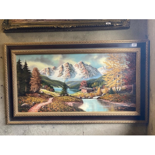 407 - Oil on canvas Alpine lake scene in Autumn. Frame measures approx 68cm x 118cm. Indistinctly signed