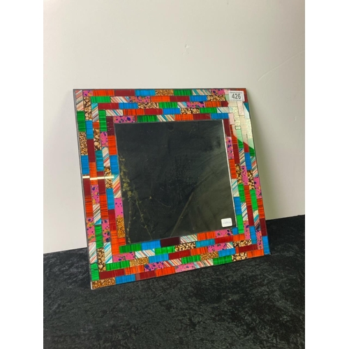 426 - A mosaic wall mirror. Approx 38cm square