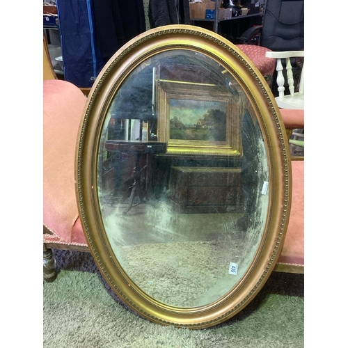 439 - Oval mirror, some marks behind glass. Frame approx 69cm x 100m