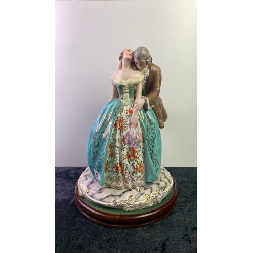 5 - Large Italian figurine of a couple in period dress on a wooden base. Approx 42cm tall.