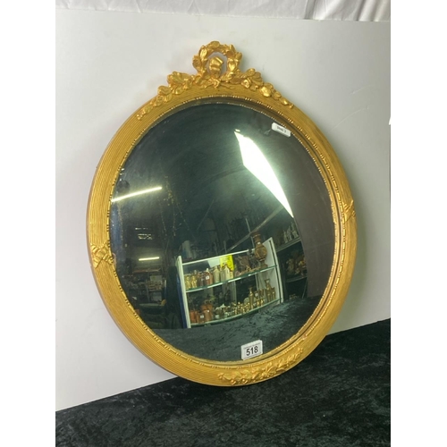 518 - Framed circular concave mirror. Approx 56cm x 50cm. Marks to the mirror face