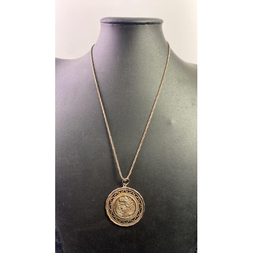 538 - Gilt metal oriental circular pendant on a silver chain