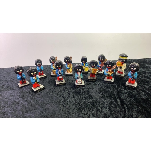 54 - 13 Robertsons hand-painted Golly figures - 12 musicians and a lollipop man