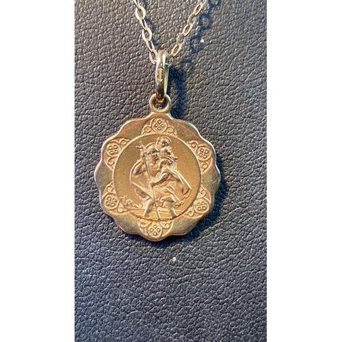 562 - A 9 carat gold St Christopher pendant on a 9 carat gold chain. Total weight 2.3g