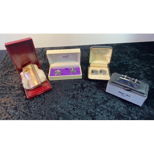 576 - Three boxed sets of cufflinks along with a cigarette lighter with etched ship design