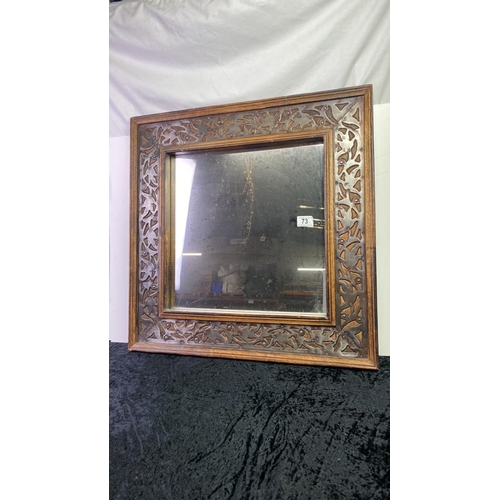 73 - Mirror in intricate frame with inset metal detail. Approx 64 x 64cm