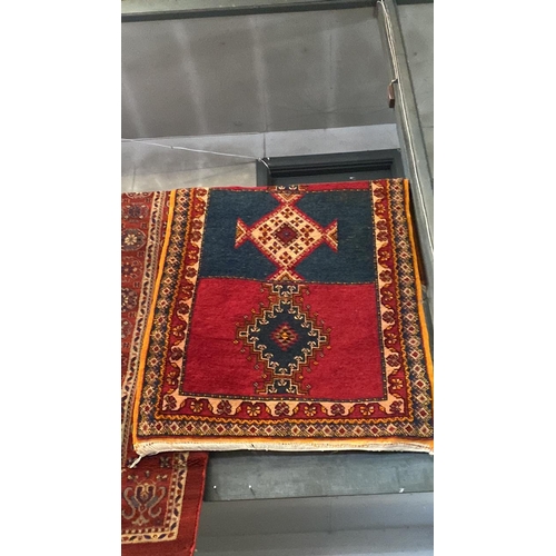 793 - Red wool rug, approx 100cm x 178cm