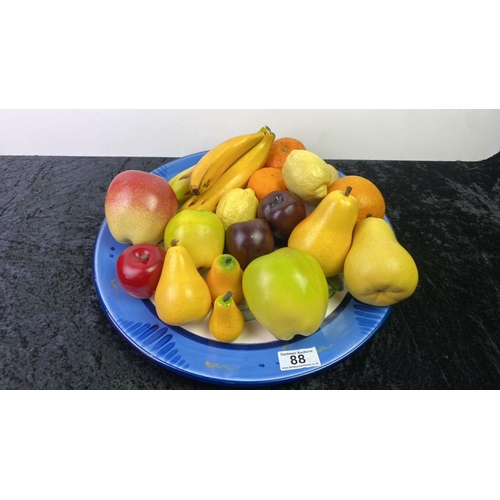 88 - Large decorative painted pottery plate along with a good selection of ceramic fruit