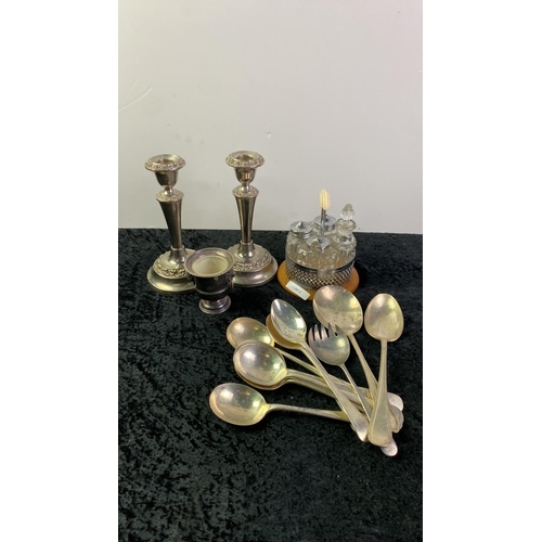 1072 - Collection of silver plated items including candle sticks cutlery.