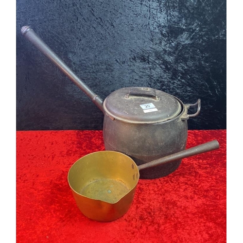 20 - A large iron saucepan along with a smaller brass example