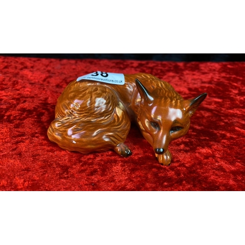 38 - A Beswick sleeping fox Number 1017