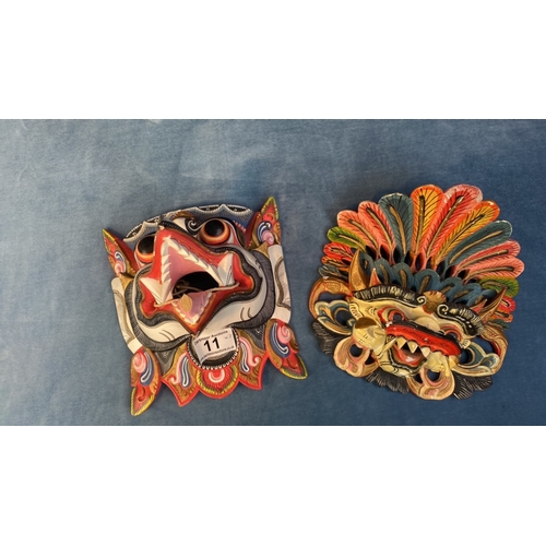 11 - Two Balinese painted wooden masks, one depicting the god Garuda (a/f) and another similar (some chip... 