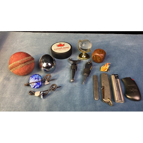 170 - Collectible incl. an ice hockey puck, cricket ball, bottle stoppers a metal egg, lighters, penknives... 